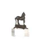 A Roman bronze figure of a horse, 2nd century AD, with right foreleg raised, standing on a