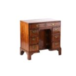 A George II walnut caddy topped lady's kneehole desk, with crossbanded and quarter veneered top