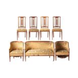 An Edwardian inlaid mahogany seven-piece salon suite, comprising a bow backed two-seater settee a