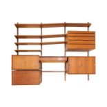 In the manner of Poul Cadovius, a suite of teak wall mounted furniture and shelves, to include