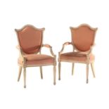 A pair of French Louis XVI style white painted shield back fauteuils, 20th century. With carved,