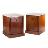 A pair of Victorian marble topped mahogany console cupboards, the white marble tops over single