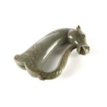 A Mughal style carved green jadeite Khanjar handle in the form of a horse's head. 15 cm long x 11