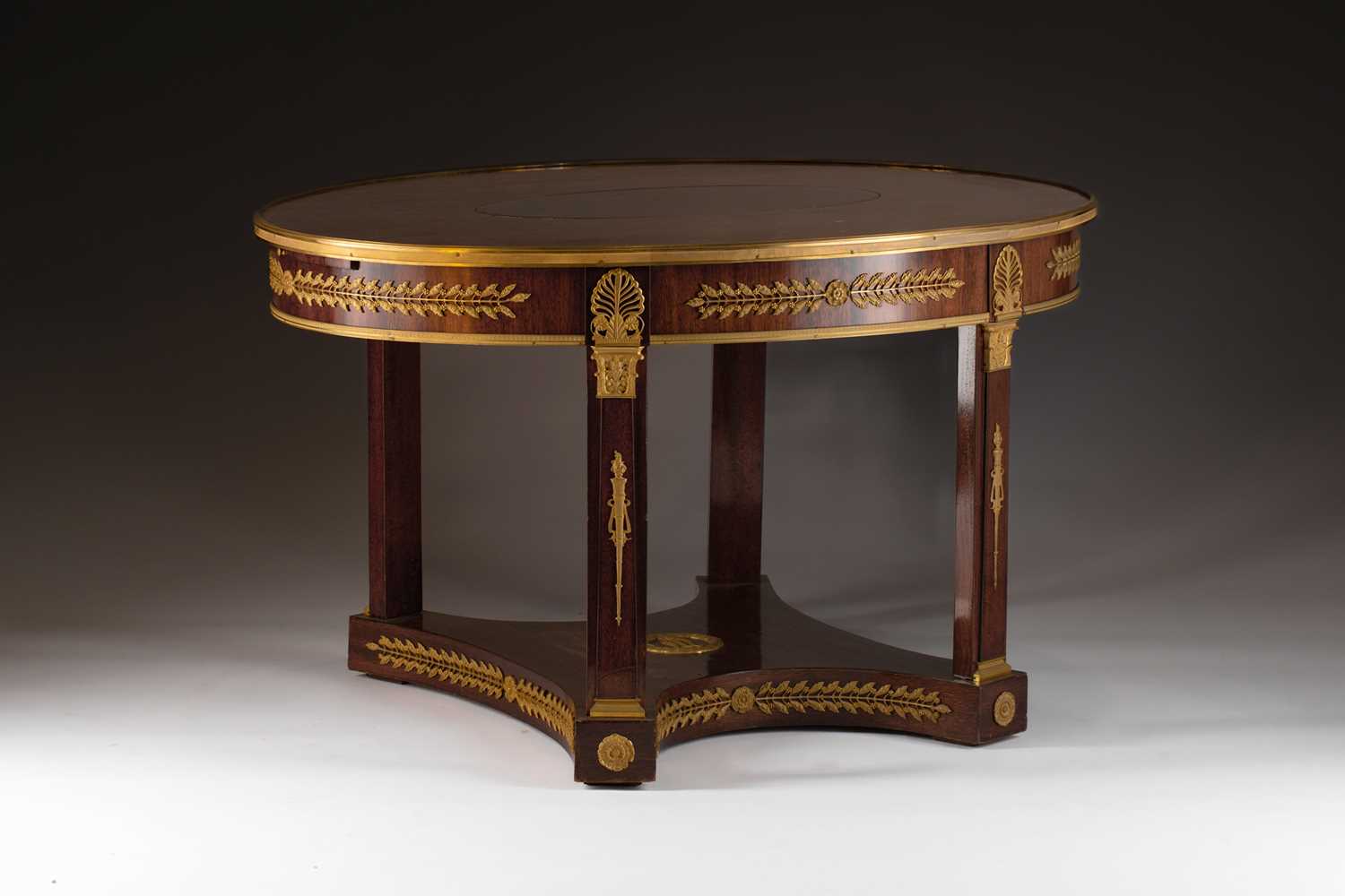 An Empire-style ormolu mounted mahogany oval center table, possibly Spanish first quarter of the