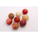 A collection of eight late 19th/early 20th century ivory snooker (or billiard) balls, the largest