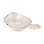 An Indian carved rock crystal oblong dish with perched falcon handle and lotus base. 13.5 cm long