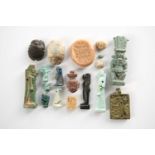 A collection of ancient Egyptian antiquities, comprising a faience amulet of Bes, Ptolemaic