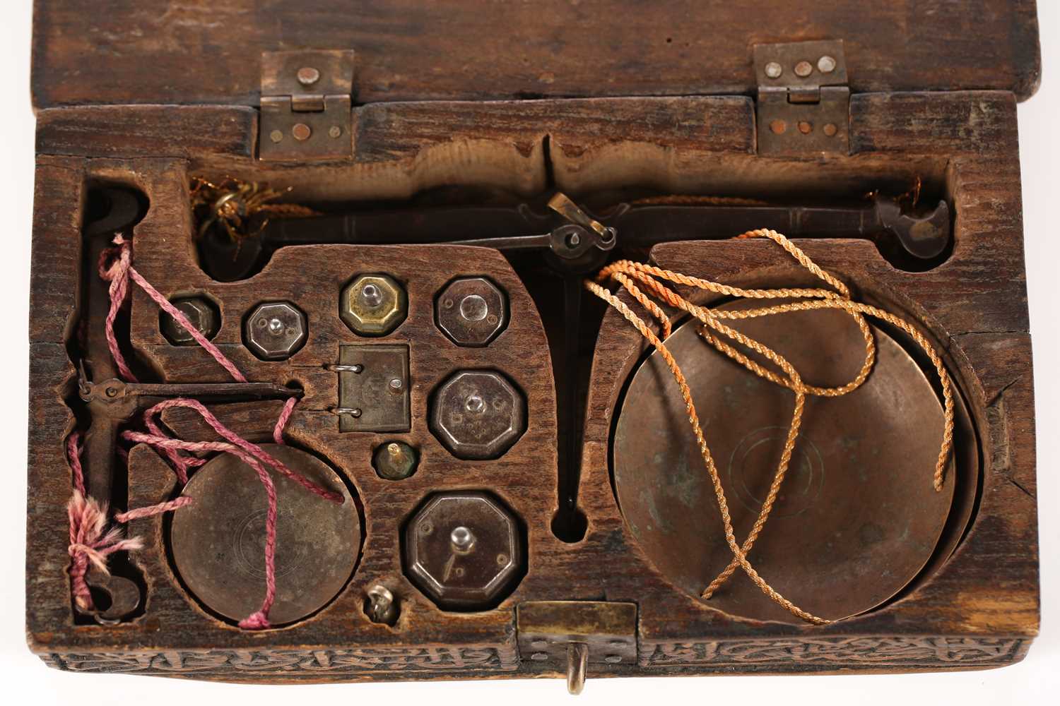 An Eastern coin scale in a fitted teak case carved with Islamic script, with two beams and pans in - Image 3 of 4