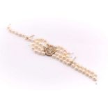 A diamond and pearl bracelet; the three rows of cultured, off-circular pearls of roughly uniform
