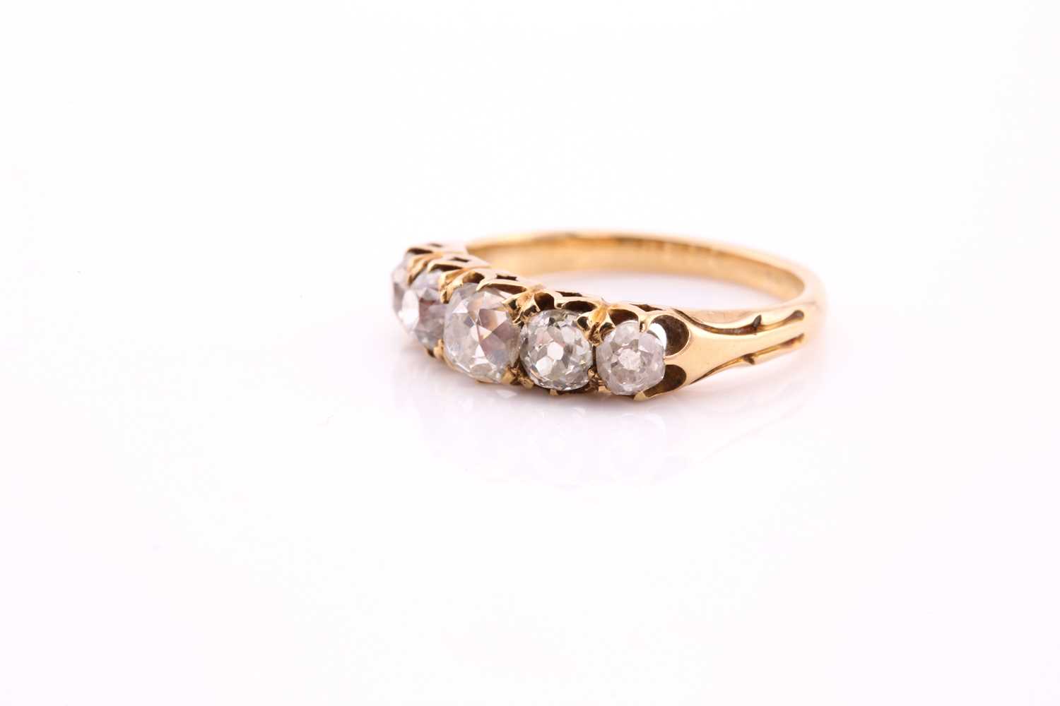 A five stone half hoop diamond ring; the graduated, mixed old cut diamonds claw set within carved - Image 2 of 4