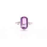 An amethyst and diamond dress ring, consisting of a central fancy cut amethyst measuring 16x10mm
