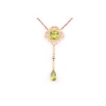 A peridot pendant necklace, early 20th century, the pendant centred by a cushion shape peridot,