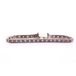 An old cut diamond line bracelet, consisting of thirty-two round old cut diamonds weighing