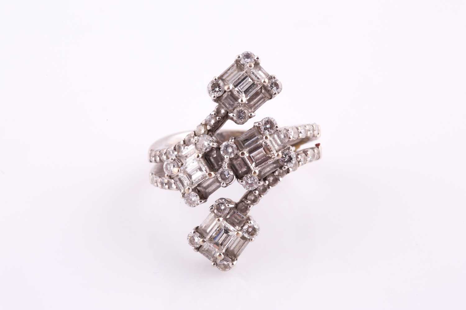 A diamond dress ring Of bifurcated design, obliquely-set to the front with four clusters of baguette - Image 6 of 6