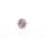 A diamond set cluster ring, consisting of a rub-over set central fancy cut diamond measuring 6.