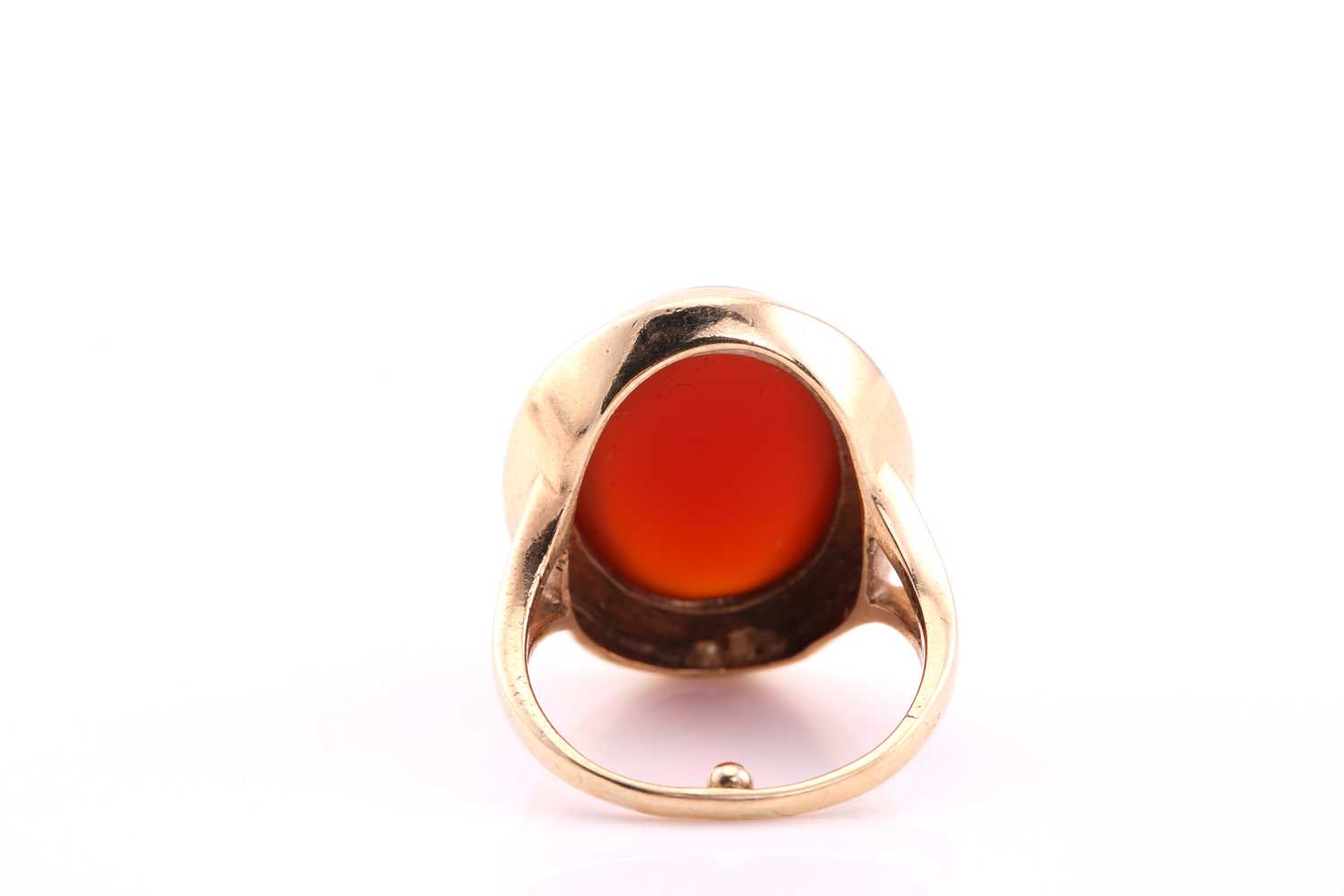 A carnelian cabochon ring, mid 20th century, the 19 x 14.5mm oval cabochon collet set to a yellow - Image 4 of 4