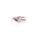 A single stone diamond ring; the round brilliant cut diamond in 9ct white gold crossover mount