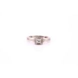 A diamond cluster ring; the princess cut diamond in round brilliant cut diamond halo mount, with