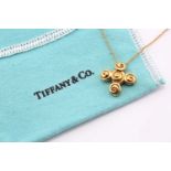 A Tiffany and Co 18ct yellow gold spiro swirl rosebud pendant with a trace link chain measuring 40cm