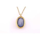A sapphire and diamond pendant, the oval cabochon sapphire 60.40cts surrounded by fifty-five round