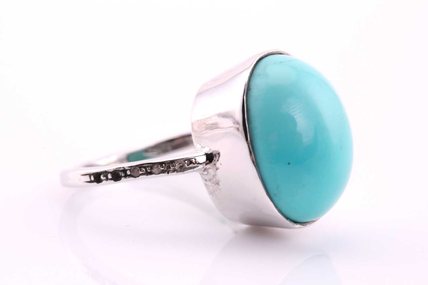 A turquoise and diamond ring, the oval cabochon turquoise, 17.4mm by 13.6mm set in white metal - Image 2 of 4