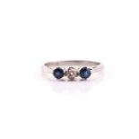 A sapphire and diamond three stone half hoop ring; the central old brilliant-cut diamond in claw