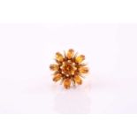 A citrine set cluster ring, consisting of a central round citrine measuring 6.3mm approximately,