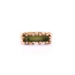 A 9ct yellow gold jade ring, with a bark effect castellated shoulders, to a polished shank, assay