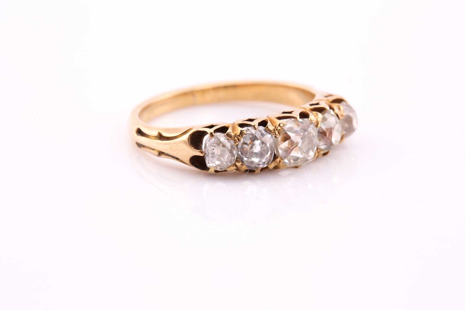 A five stone half hoop diamond ring; the graduated, mixed old cut diamonds claw set within carved - Image 3 of 4