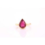 A rubellite single stone ring, pear cut with 18ct gold rub-over setting, ring size M, 4.5grams