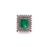 An emerald and diamond cluster ring, the rectangular step cut emerald within a two row surround of