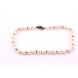 A single strand freshwater pearl necklace, the oval cream pearls from 12-15mm diameter, with a