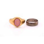 A gentleman's yellow precious metal signet ring, inset with a plain oval hardstone, ring size Z,