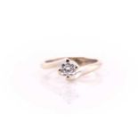 A single stone diamond ring; the round brilliant cut diamond in four claw crossover mount, to a