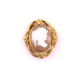 A Victorian shell cameo brooch, the central swivel oval with carved classical female profile