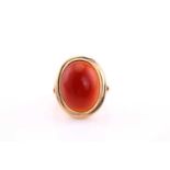 A carnelian cabochon ring, mid 20th century, the 19 x 14.5mm oval cabochon collet set to a yellow
