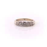 A five stone half hoop diamond ring; the graduated round brilliant cut diamonds in claw mounts to