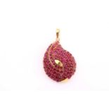 A Burmese ruby set pendant/brooch, of teardrop form with ninety oval mixed cut rubies, 15.00cts, set