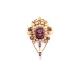 A Victorian amethyst, diamond and seed pearl ornate brooch, with central rose cut diamond floral