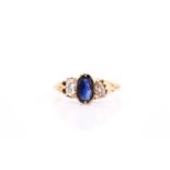 A sapphire and diamond three stone ring, the oval mixed cut sapphire approximately 7.5mm by 5mm,