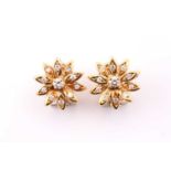 A pair of 18 carat yellow gold and diamond foliate cluster earrings; the eleven stone round