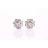 A pair of moissanite-set daisy-head cluster earrings, set with central round claw set brilliant