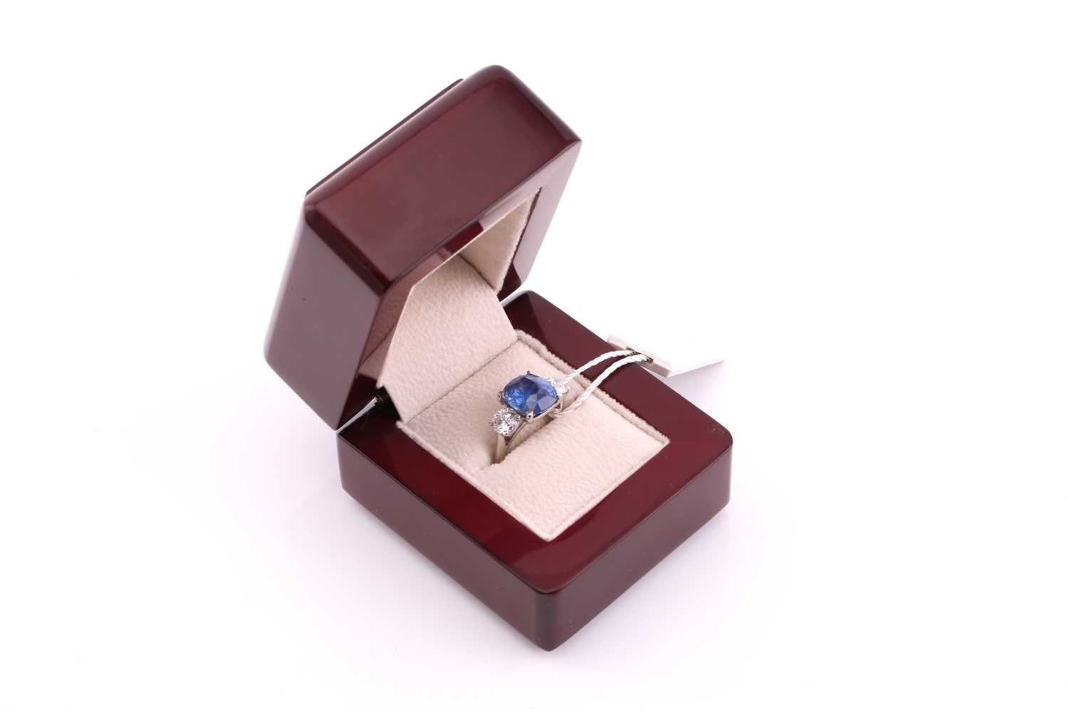 A sapphire and diamond three stone ring, the cushion mixed cut sapphire 4.21 carats, flanked two - Image 6 of 12