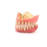 Pair of false teeth with gold content, 53.8 grams all inCondition report: Tested as 18k gold plus