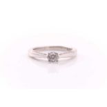 A single stone diamond ring; the round brilliant cut diamond in four claw mount, with diamond-set 18
