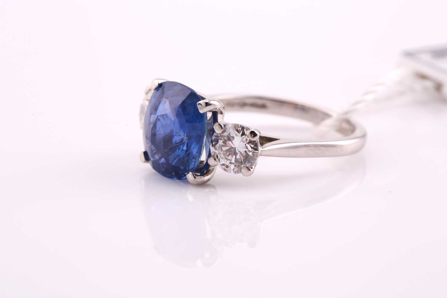 A sapphire and diamond three stone ring, the cushion mixed cut sapphire 4.21 carats, flanked two - Image 3 of 12