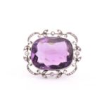 An Edwardian amethyst and rose-cut diamond brooch, consisting of a large cushion antique cut