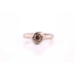 A brown diamond and 18ct white gold ring, featuring a round brilliant-cut brown diamond rub over set