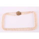 A double-strand cultured pearl necklace with 9ct gold clasp, the two strands of uniform pearls