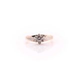 A single stone diamond ring; the round brilliant cut diamond in raised, scalloped, bi-coloured 14